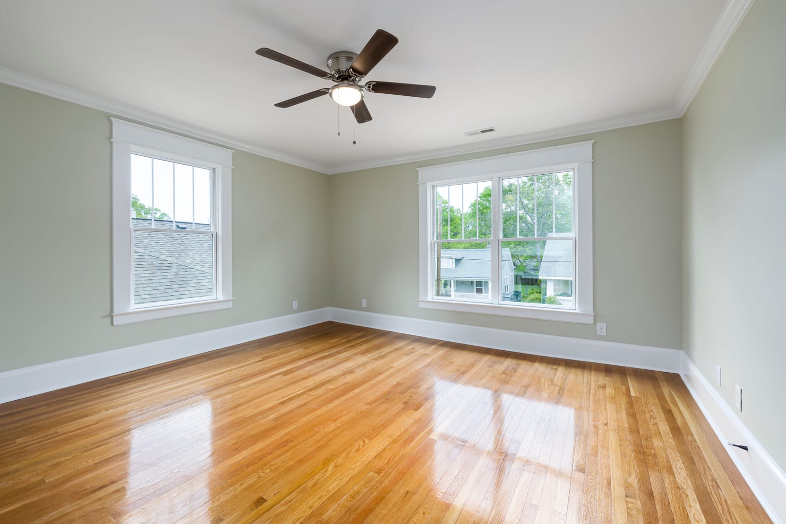 Close-up architectural photograph of custom finished hardwood flooring plank with seamless bevel and lustrous satin sheen
