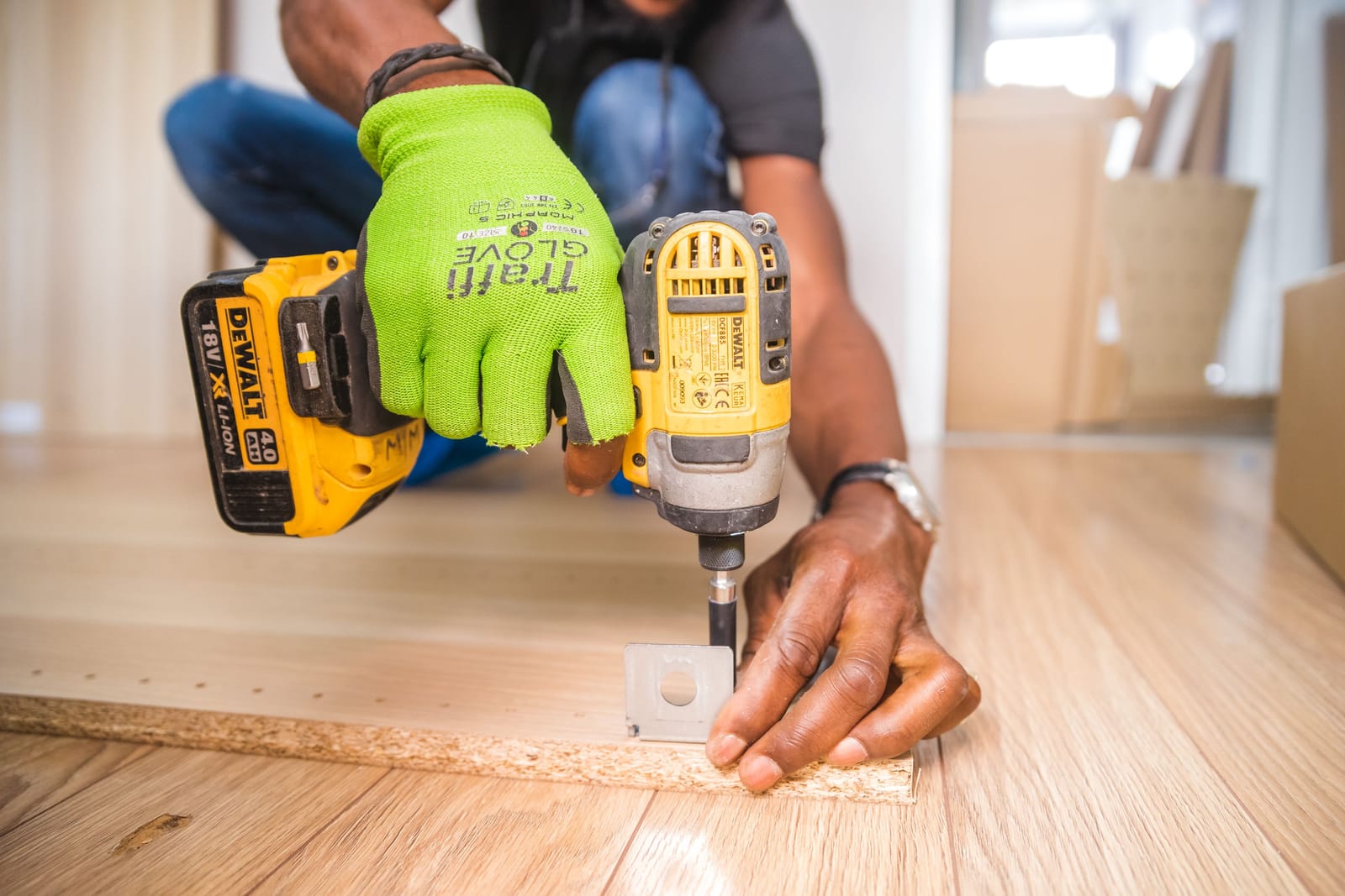 Craftsman fitting a custom hardwood replacement plank into existing floor seamlessly