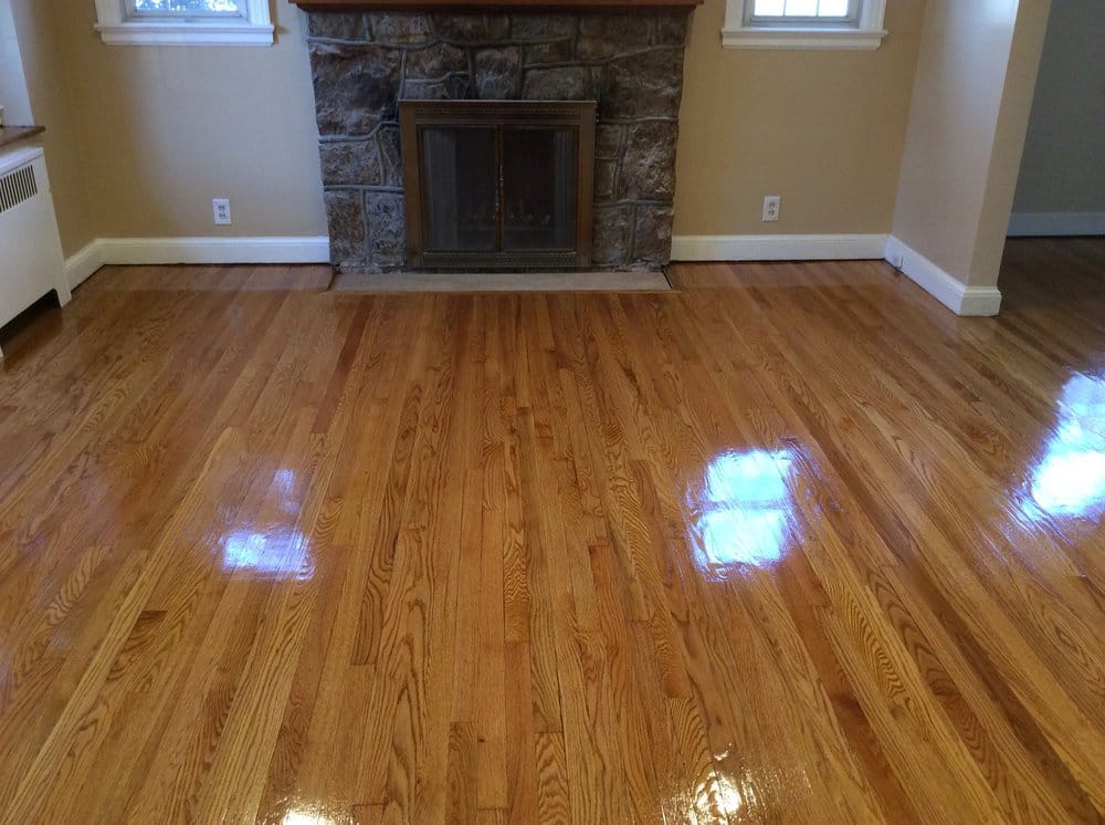 Living room with stone fireplace and refinished oak floor