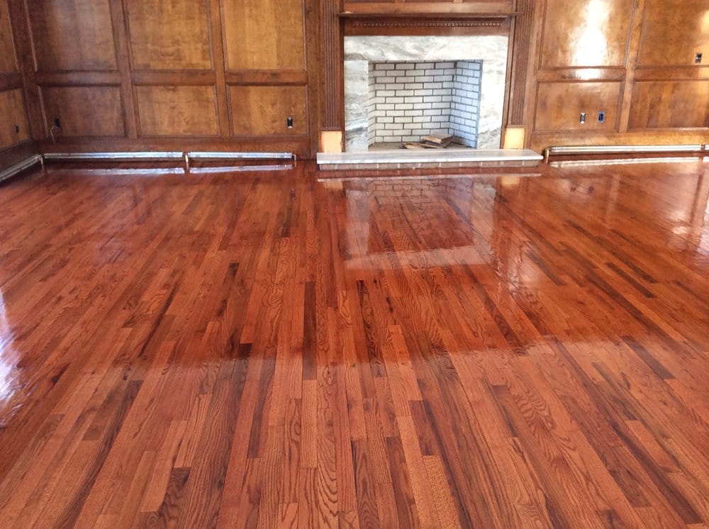 Wood paneled room with a finished glossy oak floor