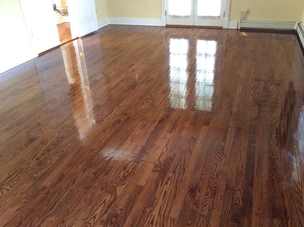Glossy finished oak floor beside a fireplace