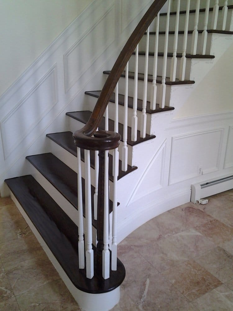 Curved white staircase with restored wood treads
